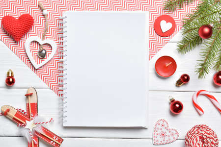 Top view writing New Year's goals or a shopping list on a blank sheet of paper. Christmas layout....