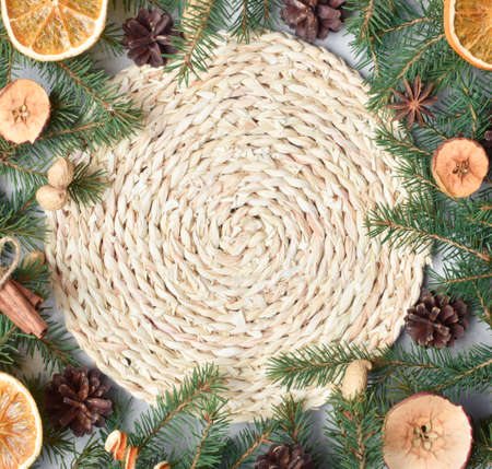 Background of Christmas decor in an eco-stele of fir branches and cones, dried oranges, apples. Flat layout, top view, place to copy.の写真素材