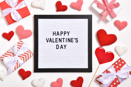 A felt board with the inscription Happy Valentines Day lies among the gifts. Copy space. Flat lay,...