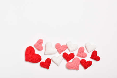 Various knitted hearts lie in heaps. Background for Valentines Day. Copy space. Flat lay, top viewの写真素材