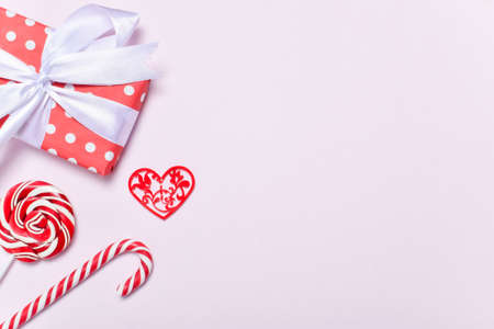 A Valentine's Day card. The banner is festive. Lollipops, a gift and hearts on a pink background....