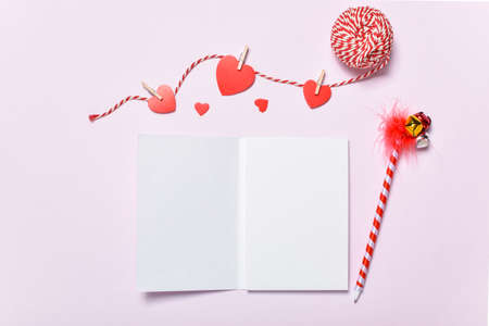 Layout of an empty notebook for a romantic meeting. Background for a copy space for Valentine's Day with gifts and knitted hearts. copyspace. Flat lay, top view.の写真素材