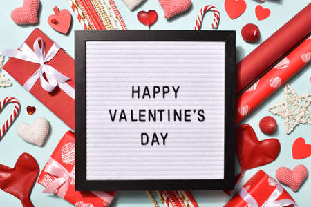 Felt board with happy Valentine's day inscription around holiday decorations.の写真素材