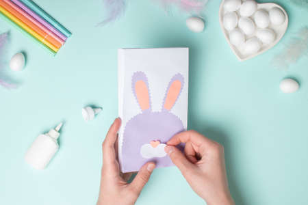 A paper bag for gifts and treats for the Easter holiday. DIY Easter bunny concept. Step by step...