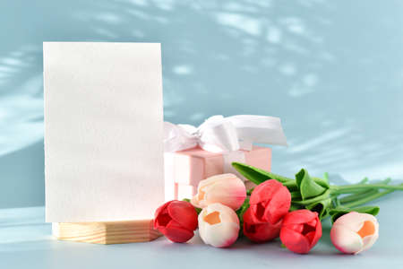 Layout of a postcard with tulip flowers and a gift. copy space