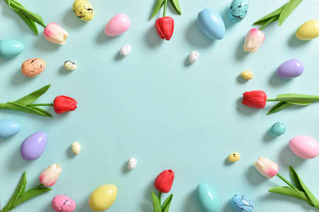 Frame with tulip flowers, Easter colored eggs. Decor for the feast of Holy Easter. Space for...