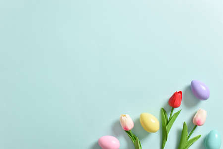 Background with rabbit ears, Easter eggs and tulip flowers. Happy Easter. Decor for the feast of Holy Easter. Space for copying. Flat position, top view.の写真素材
