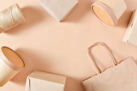 Paper packaging on a beige background. Food delivery, takeaway. Eco packaging. Zero waste. Flat...