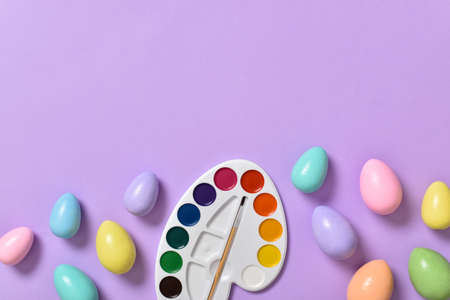 Easter background with painted eggs, and paints. Space for copying. Flat position, top view.の写真素材