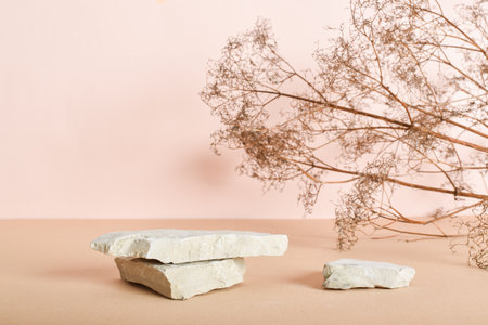 Two stone catwalks with dried flowers on a beige background. Abstract eco podium for organic...