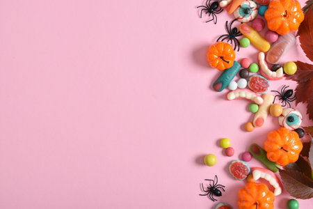 Various sweets on a pink background. Happy Halloween. copyspace. Flat lay, top view.の写真素材
