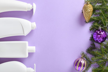 Christmas cleaning. Plastic white bottles with detergent for disinfection of fir branches and Christmas tree toys on a light purple background.の写真素材