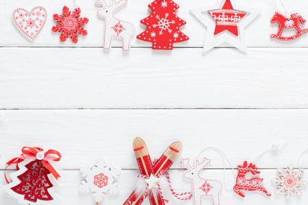 Christmas composition with red and white Christmas tree eco-toys on a white wooden background. Happy New Year and Merry Christmas. Space for copying. Flat position, top view.の写真素材