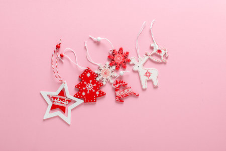 Christmas composition with red and white Christmas toys on a light pink background. Happy New Year and Merry Christmas. Space for copying. Flat position, top view.の写真素材