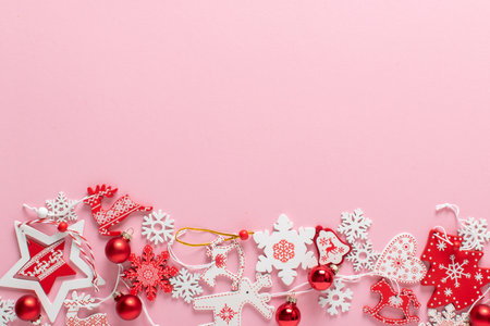 Christmas composition with red and white Christmas tree eco-toys at the bottom on a light pink background. Happy New Year and Merry Christmas. Space for copying. Flat position, top view.の写真素材