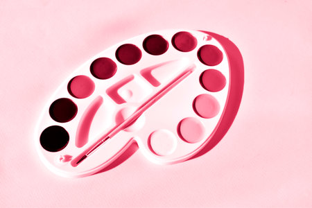 Watercolor paints in the form of an artistic palette on a Color of 2023, viva magentaの写真素材