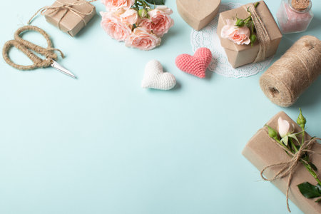 Composition for Valentine's Day of gifts in eco-packaging, natural flowers on a light blue background. Flat layout, top view, place to copy.の写真素材