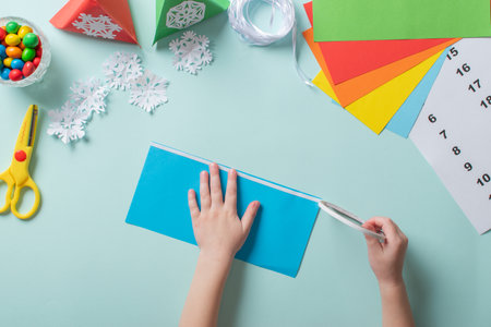 Advent calendar made of colored paper. Step-by-step instructions for making Christmas crafts. Diy for childrenの写真素材
