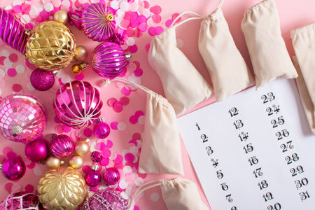 Christmas advent calendar with gift velvet bags and wooden numbers on a white background. Eco-friendlyの写真素材