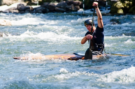 Young man in a whitewater kayak negotiating rapidsのeditorial素材