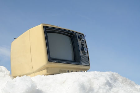 Portable vintage TV on a ski hillの写真素材