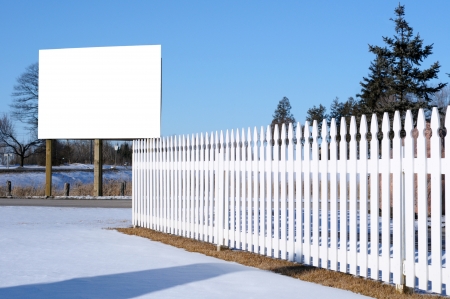 White picket fence and a billboardの写真素材
