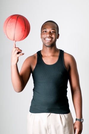Young athlete spinning a basket ballの写真素材