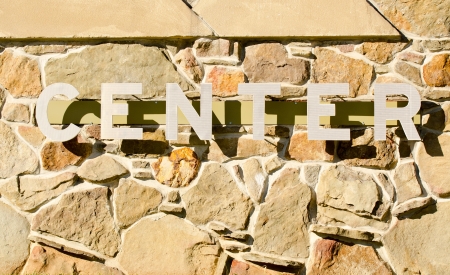 Center Sign with shadows on rock wallの写真素材