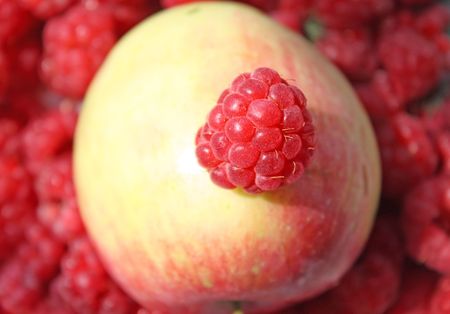 Close up of the juicy raspberry on the apple. の写真素材
