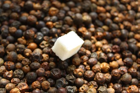 Close up of the piece of sugar on dried juniper berries