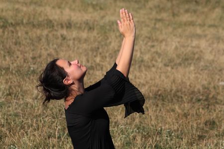Praying woman in black dressの写真素材