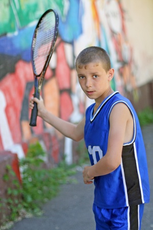 Portrait of the teenager playing badminton in a backyardの写真素材