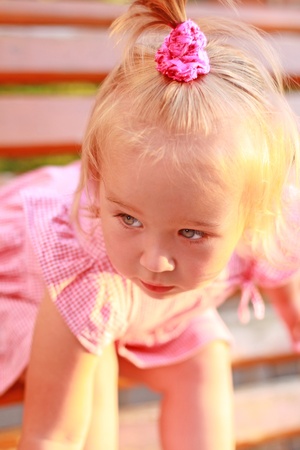 Portrait of the bended girl in a pink dressの写真素材