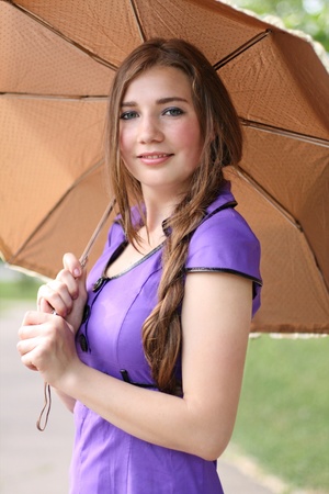 Portrait of the beautiful smiling woman holding umbrellaの写真素材