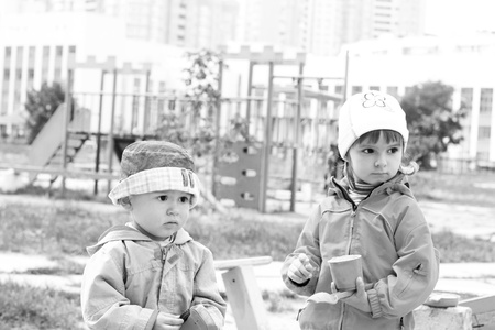 Portrait of the lovely serious children playing on the playgroundの写真素材