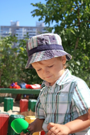 Portrait of the little boy playing in the sandboxの写真素材