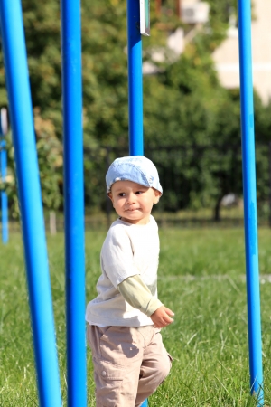 Portriat of the little mischievous boy running outdoors. Orientation in the spaceの写真素材