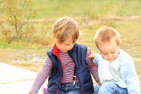 Sitting and talking. Two little boysの写真素材