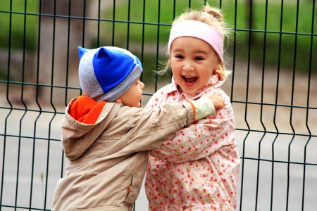 Portrait of two little kids. Hugs and smile.の写真素材