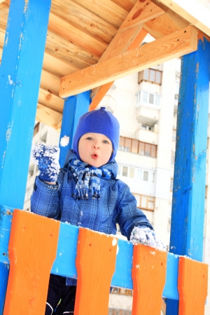 Portrait of the lovely little boy playing snowballsの写真素材
