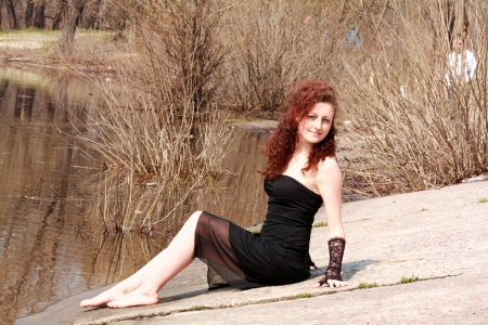 Beautiful woman in black dress outdoorの写真素材