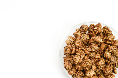 Chocolate popcorn in glass bowl on white background and copy space.の写真素材