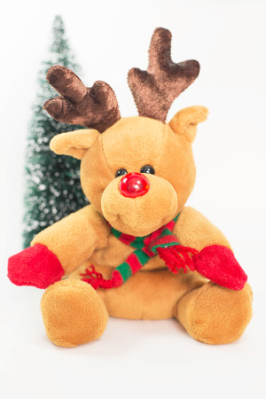 Reindeer doll with Christmas tree on white background.の写真素材