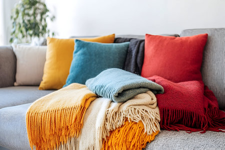 Soft textures and vibrant colors create a warm, inviting atmosphere in a stylish living space.の素材