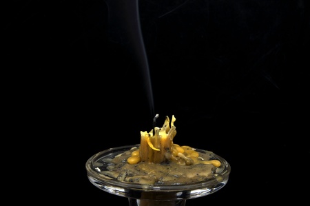 extinguished candle closeup on black backgroundの写真素材