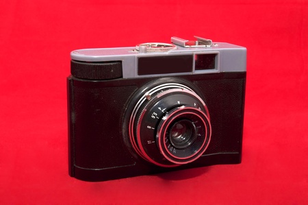 little old camera close up on a red backgroundの写真素材