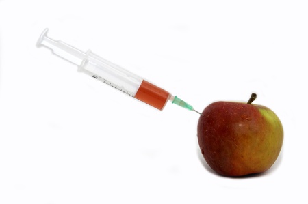 beautiful apple juice with a syringe on a white backgroundの写真素材