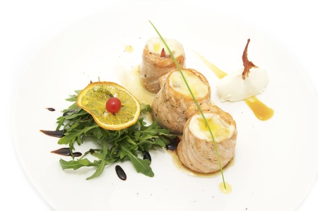 fried fish rolls with herbs on a white plateの写真素材