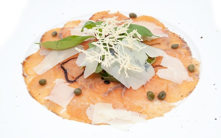 Slices of salmon with herbs and cheese on a white plateの写真素材