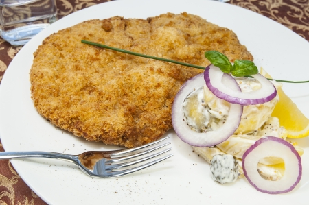 Schnitzel vegetable salad at restaurantの写真素材